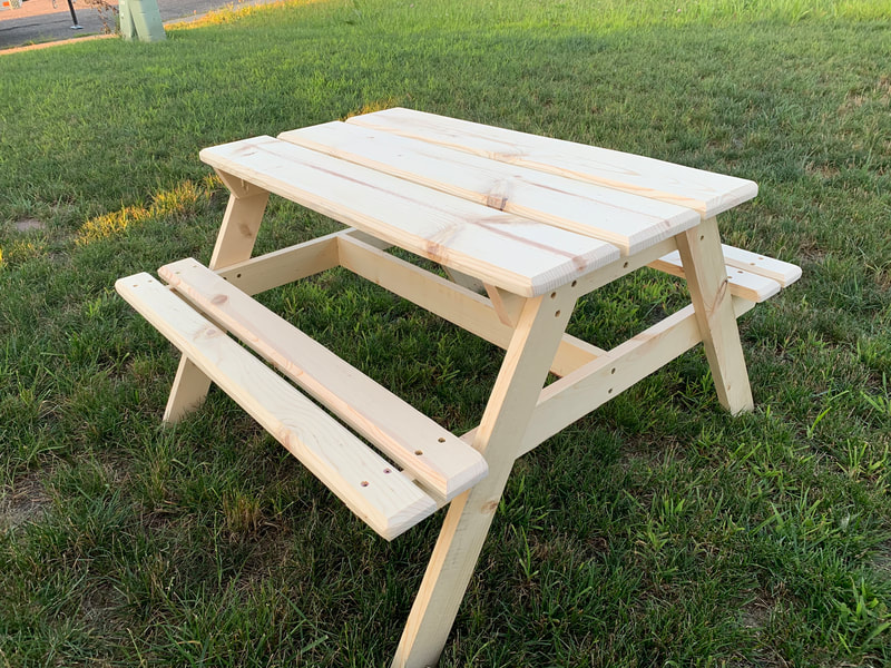 Outdoor wood picnic table made of pine. Available in large, medium or small sizes for seating up to 8 adults, 6 adults or wood picnic tables for kids. Painted or stained outdoor tables available. Many different style picnic tables to choose from.