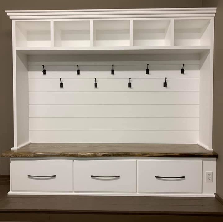 Created the perfect entry way built in shelving, seating and storage space. Stained wood was used in this project in Richmond, Minnesota to match the home style and decor. Great home design idea for decluttering your entryway and organizing shoes, coats, and more. Custom built wood entry way.