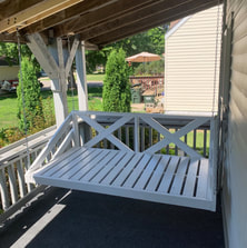 Wood front porch swing is the best way to update a front porch and create an outdoor space for entertaining and just relaxing outdoors. This outdoor furniture design complements this cottage style home in Sartell, Minnesota. The perfect home design idea for this central Minnesota house.